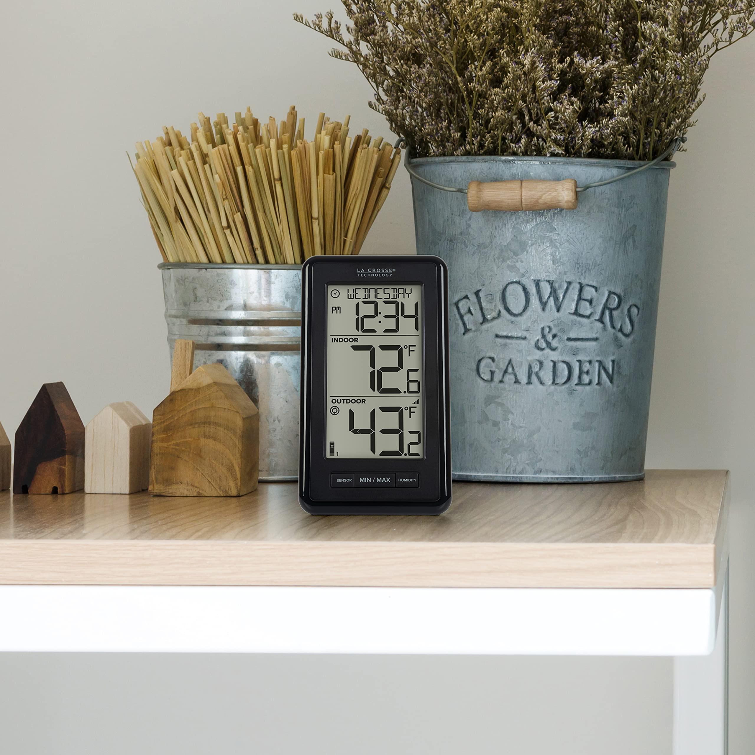 La Crosse Technology display on living room shelf illustrating home comfort monitoring