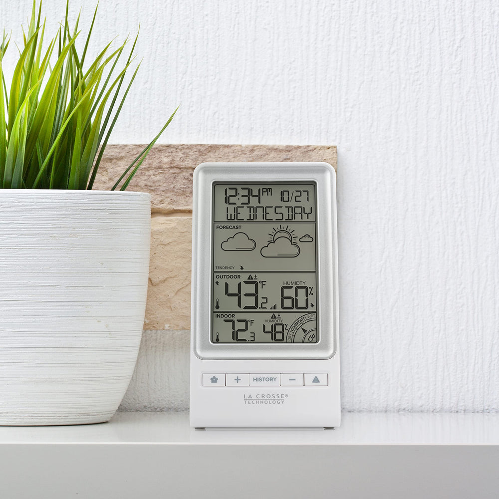 La Crosse Technology held in hand to show compact size and clear readable display