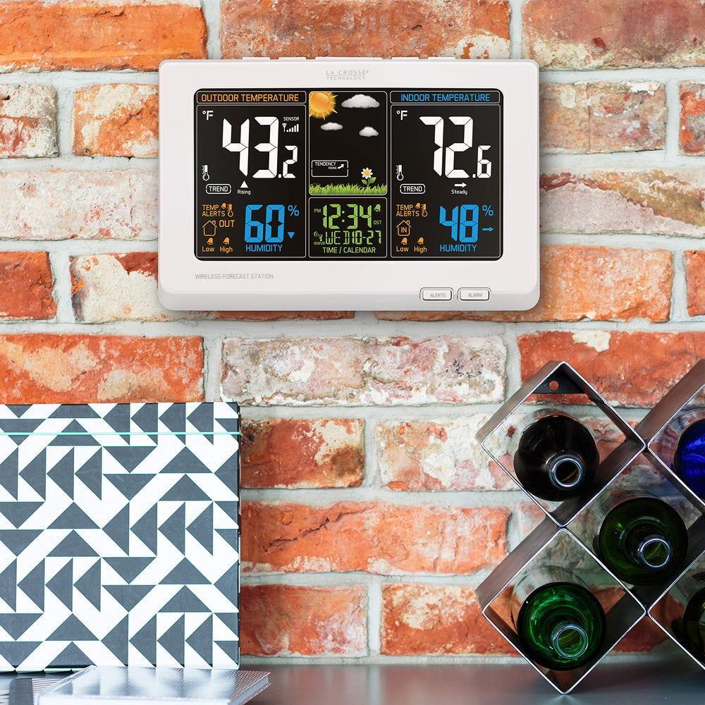 La Crosse Technology held in hand to show compact size and home-fit convenience