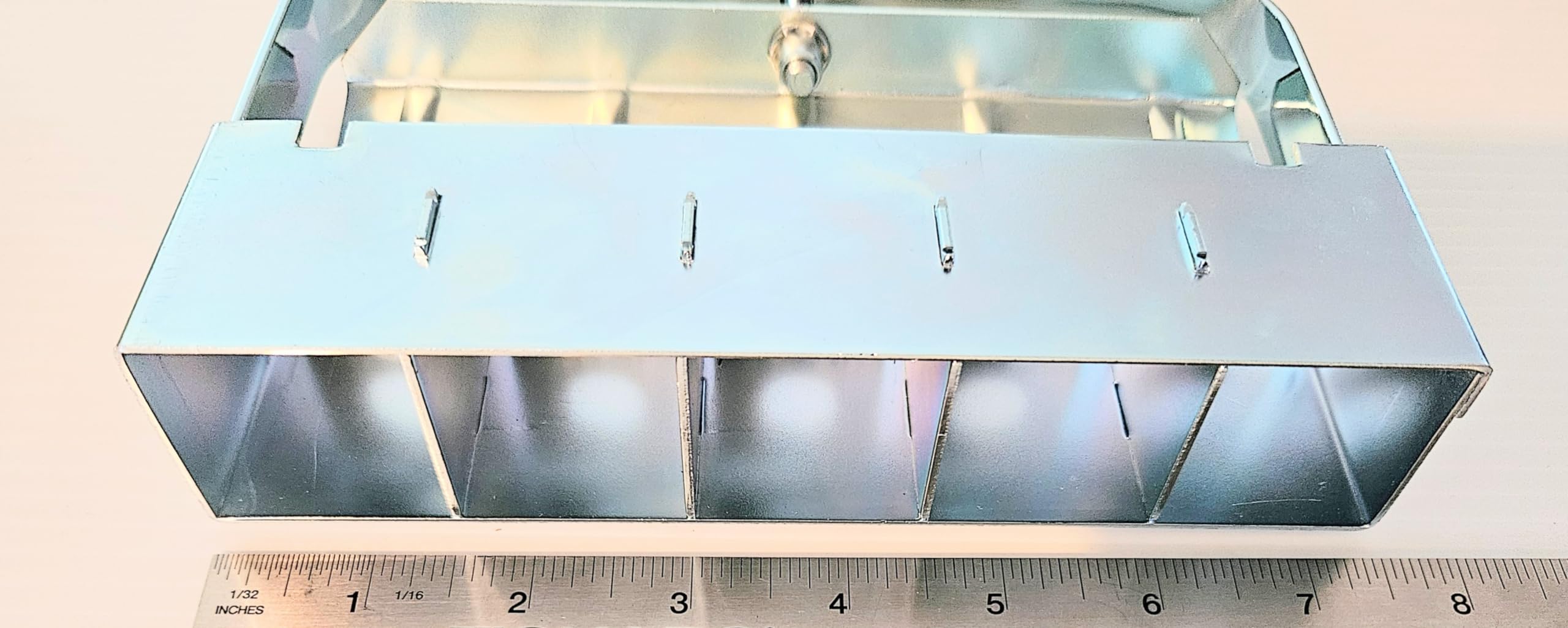 Ladbrooke Mini 5 next to a ruler showing compact size and space-saving block dimensions