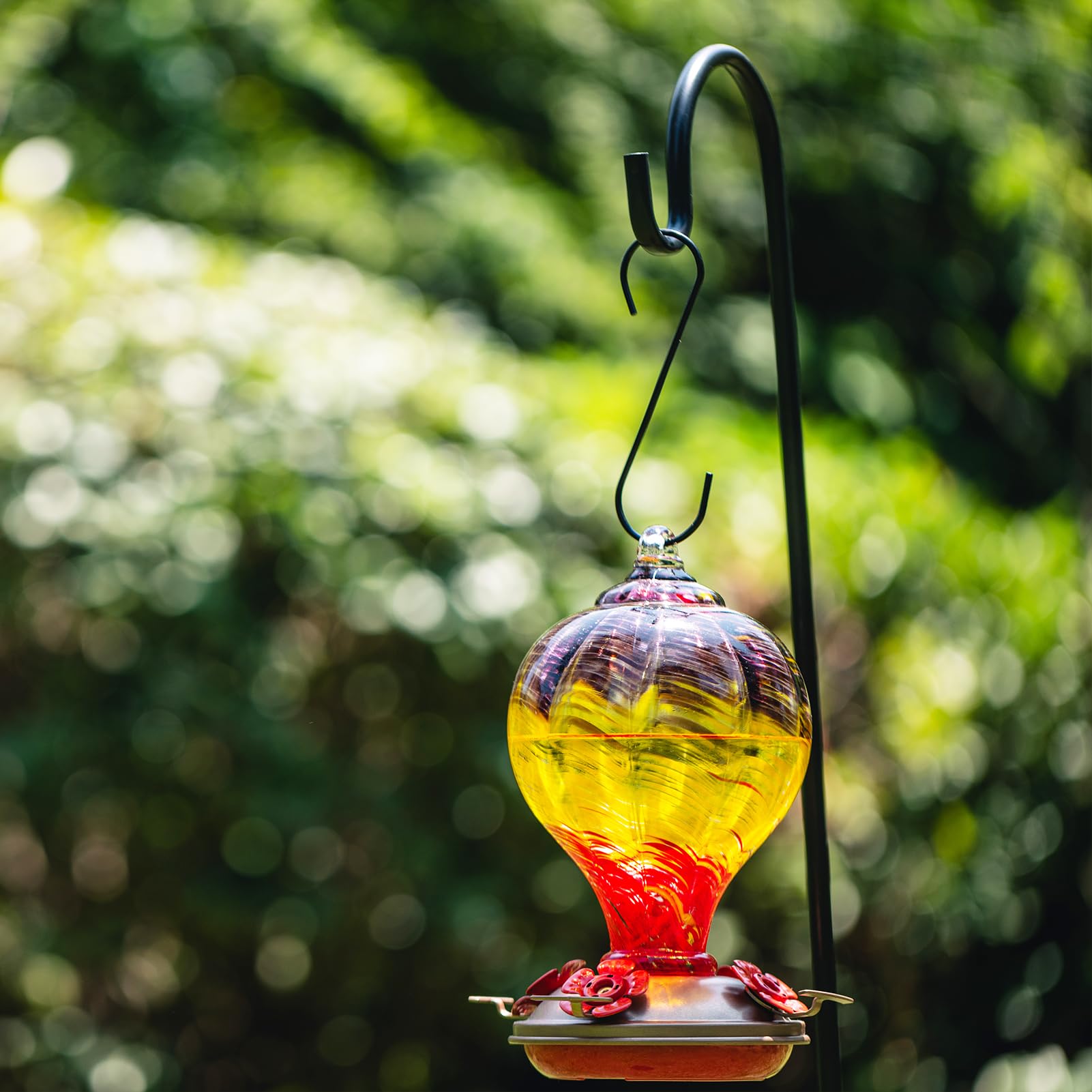 LaElvish Garden feeder hanging in garden with hummingbird attracting pollinators