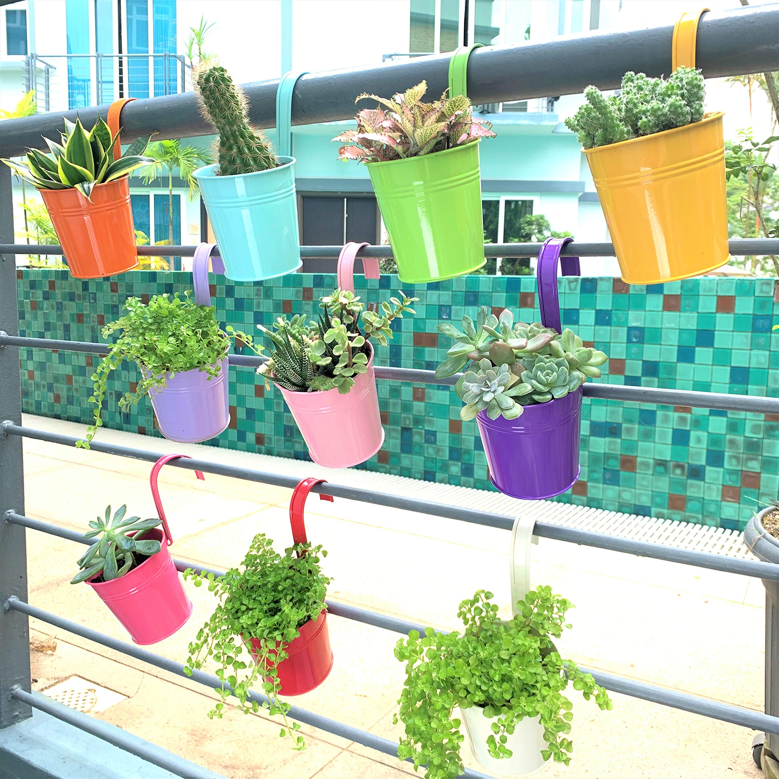LáLáGreen planters hung on a balcony rail maximizing small-space garden