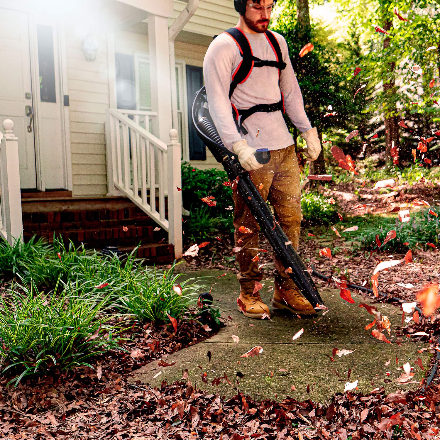 LawnMaster blower beside a rake showing size and portability benefit