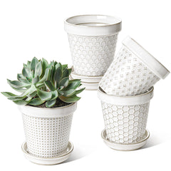 LE TAUCI front view of four arctic white pots showing embossed design and clean finish
