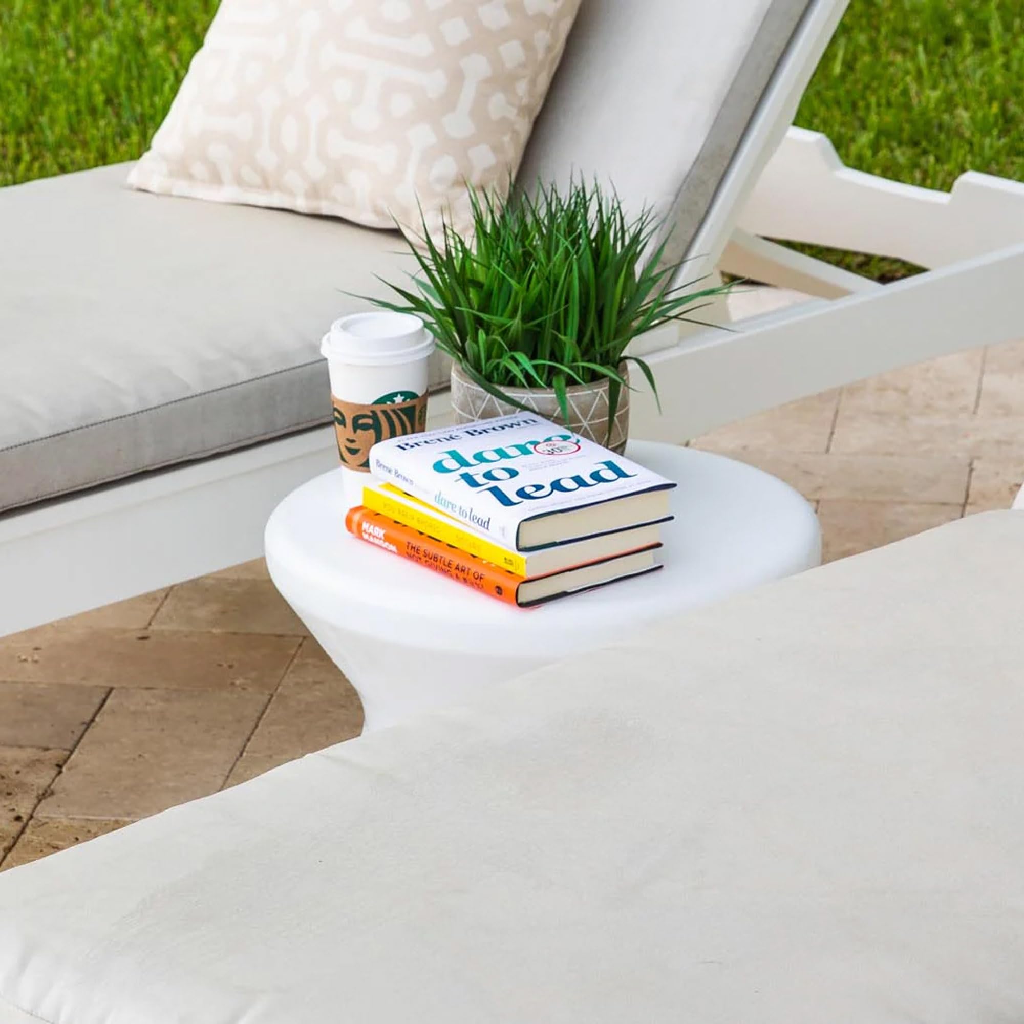 Ledge Lounger sitting on pool ledge with drinks, demonstrates secure in-pool use