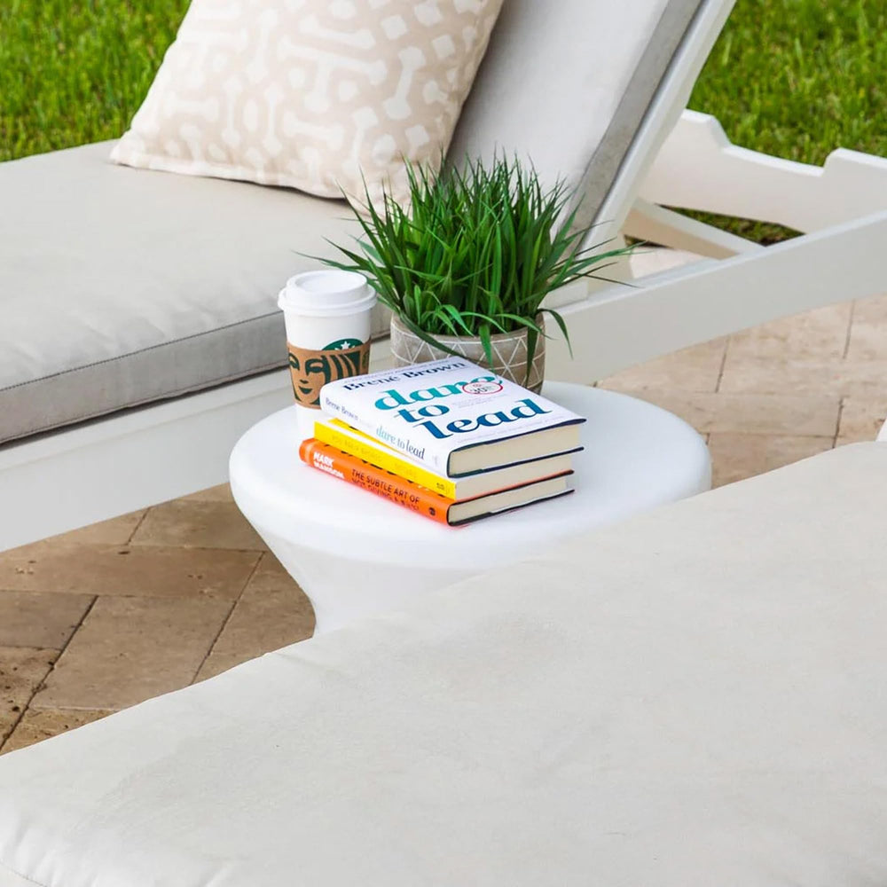 Ledge Lounger sitting on pool ledge with drinks, demonstrates secure in-pool use