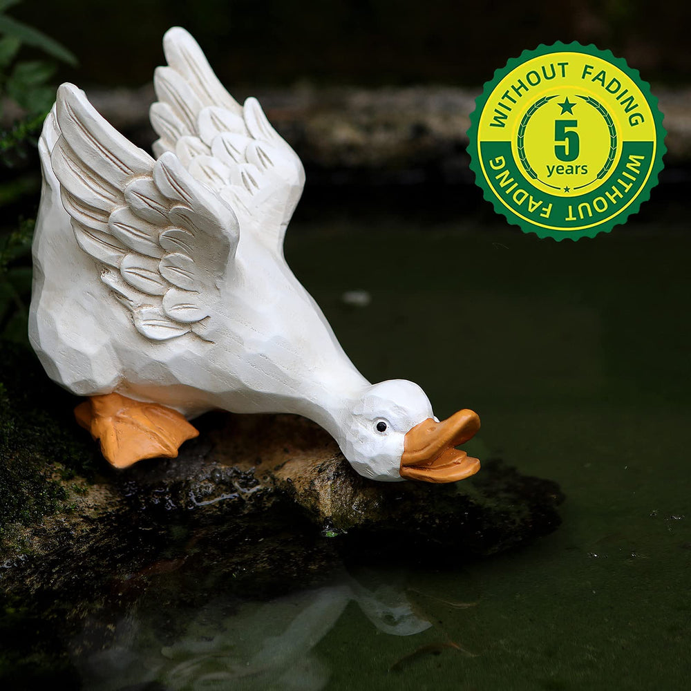 LEGIFO duck statues staged in a flowerbed adding whimsical curb appeal