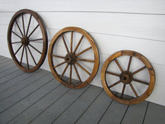 Leigh Country 24-inch wheel mounted on covered porch, creates striking outdoor focal point and atmosphere