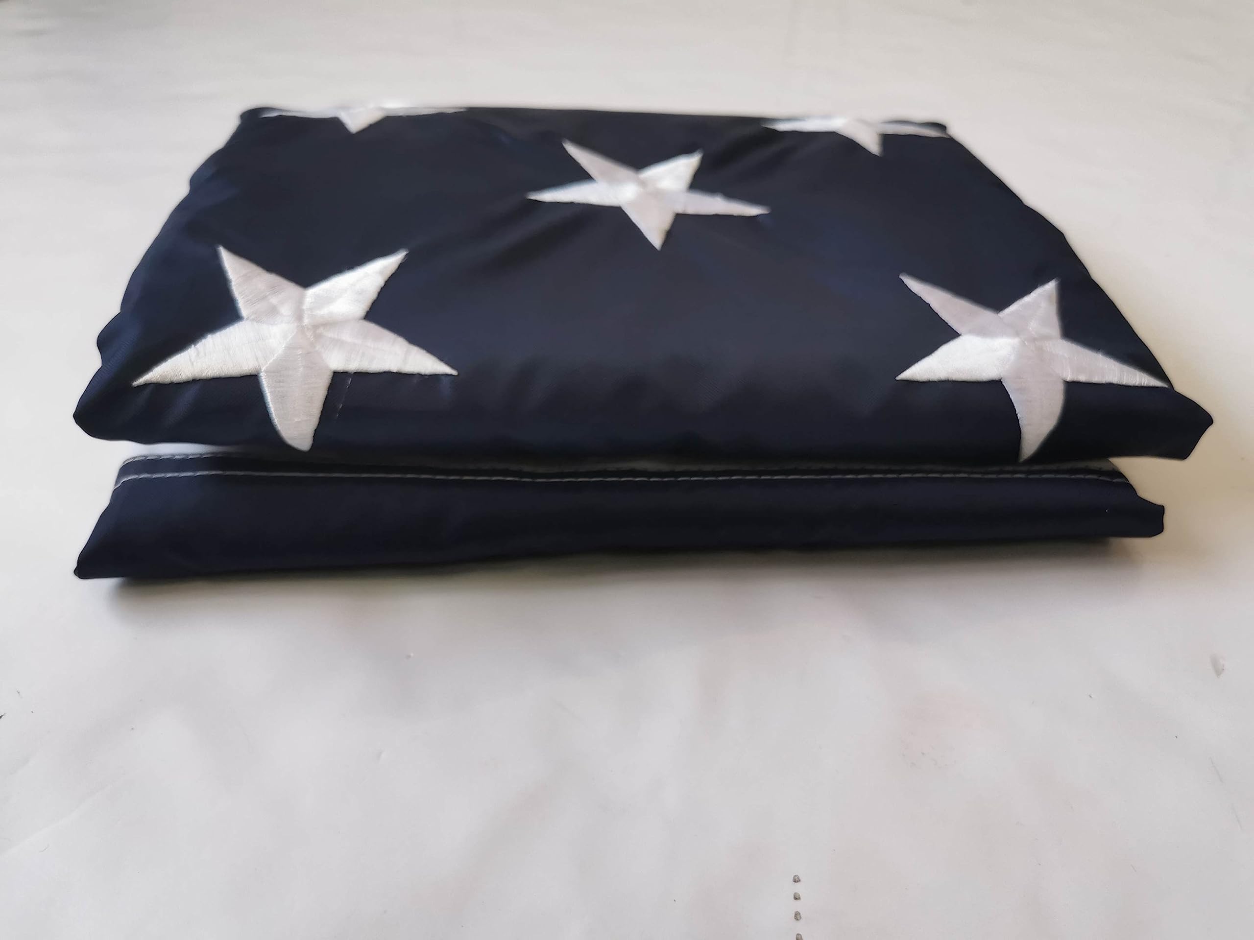 Lenex folded flag next to ruler showing size and easy storage convenience
