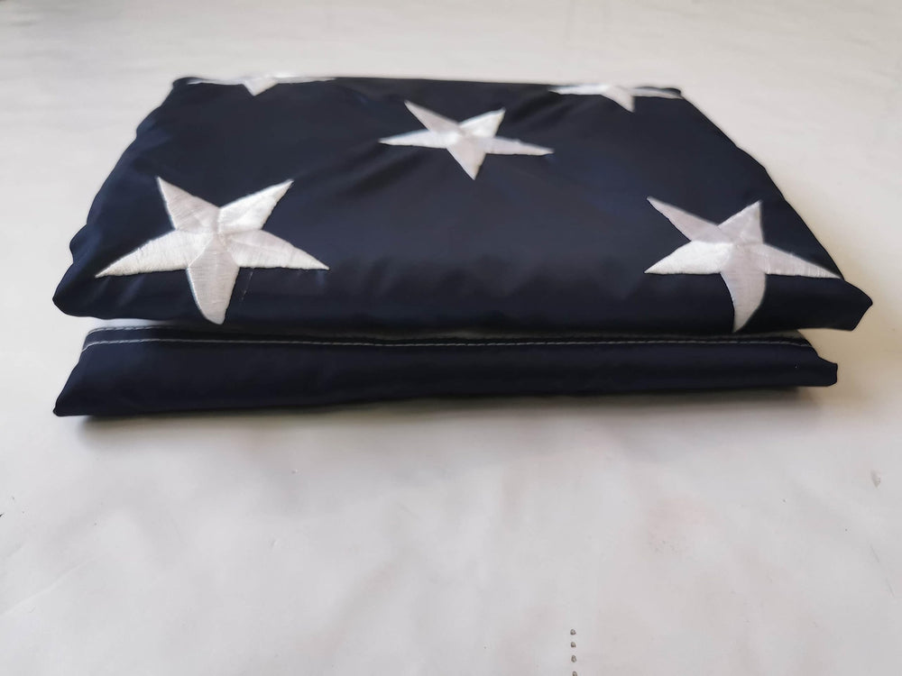 Lenex folded flag next to ruler showing size and easy storage convenience