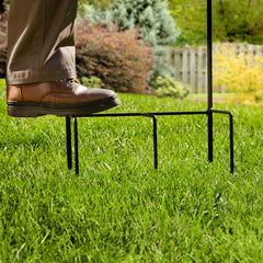 Liberty Garden anchor prongs pressed into soil demonstrating stable tool-free installation