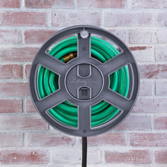 Liberty Garden Basics 510 mounted on exterior wall in backyard, saves space and organizes hose