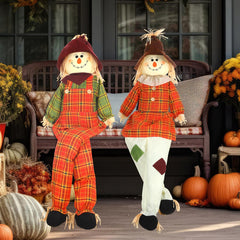 Libima front view of two sitting scarecrows creating warm fall curb appeal