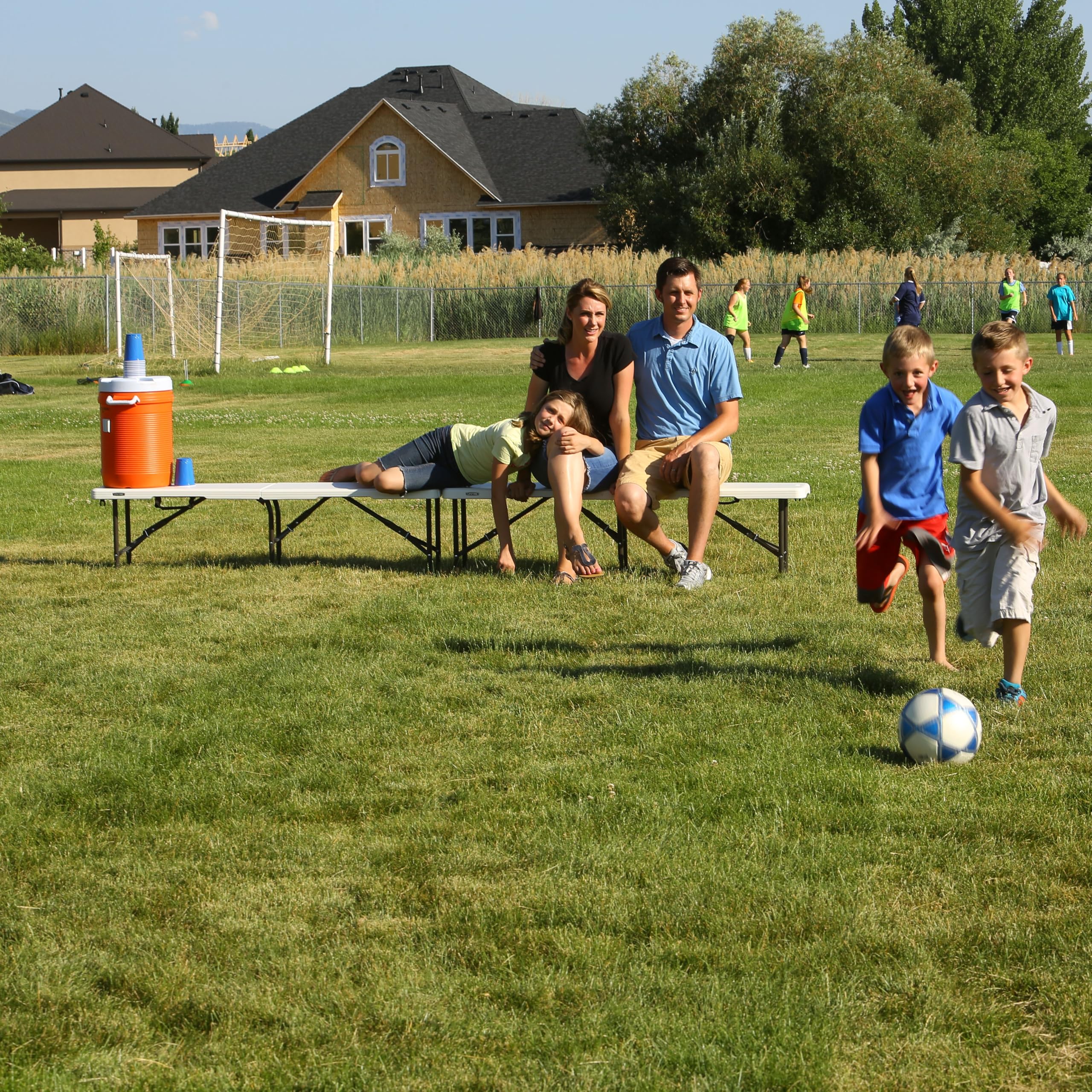 LIFETIME bench next to person for size comparison, demonstrating compact footprint