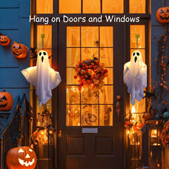Lifnatty ghosts hanging on porch demonstrating atmospheric outdoor Halloween decorating