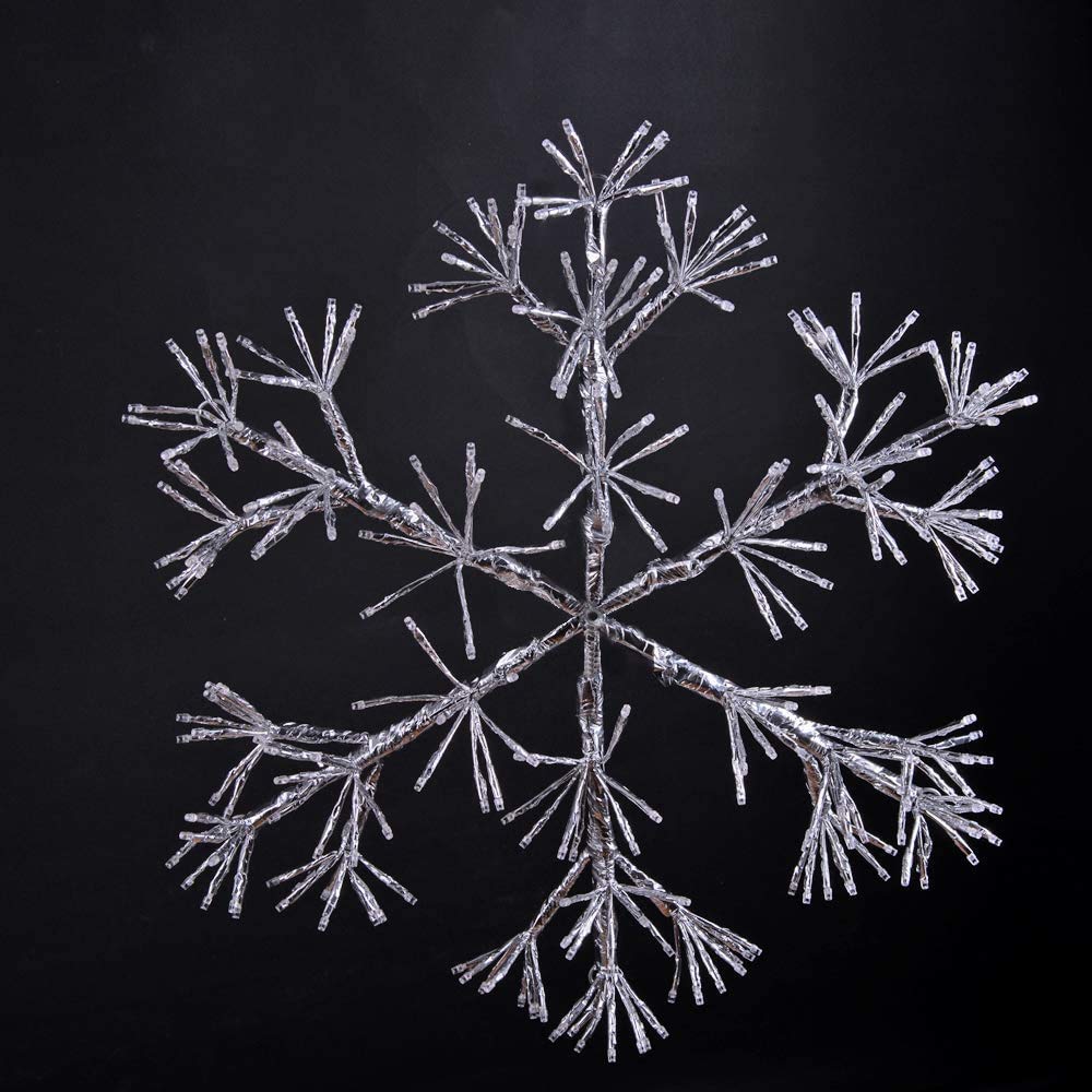 LIGHTSHARE snowflake lit in garden at dusk, adds warm ambient outdoor lighting