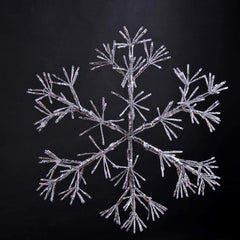 LIGHTSHARE snowflake lit in garden at dusk, adds warm ambient outdoor lighting