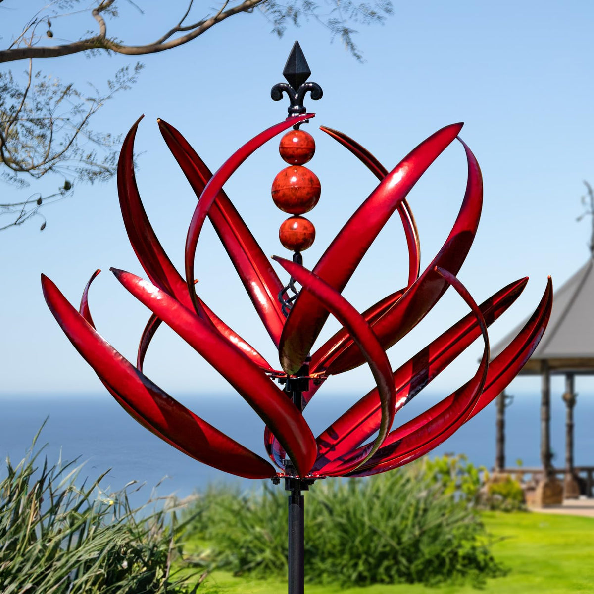 LimeHill front view of burgundy lotus wind spinner showing decorative motion benefits