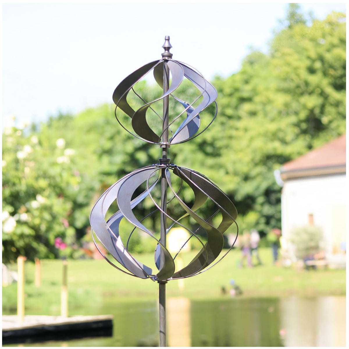 LimeHill front view of silver spherality wind spinner shows striking outdoor focal point