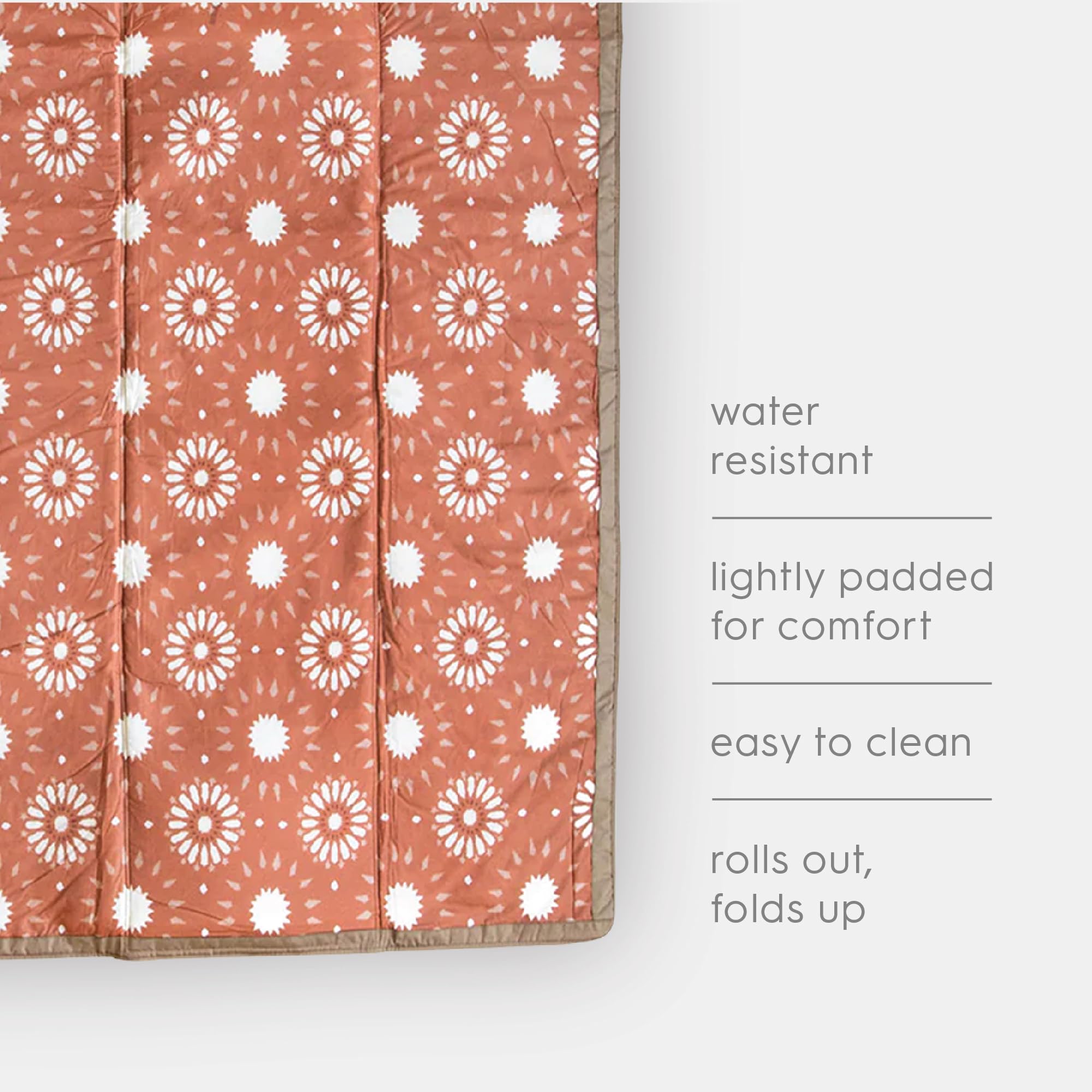 Little Unicorn next to a backpack showing compact folded size for travel