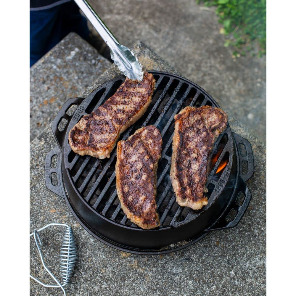 Lodge grill next to hand for scale showing portable 12 inch size advantage