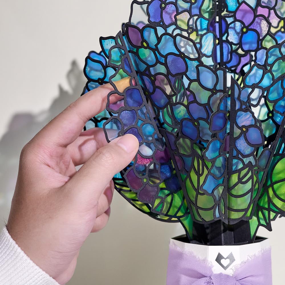 Lovepop bouquet in a sunny window casting colorful rainbow shadows on sill