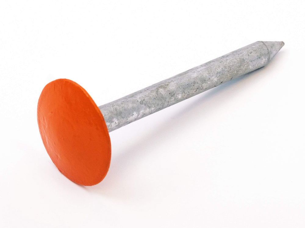 LOW PROFILE SURVEY STAKE beside ruler showing compact size, precise scale reference