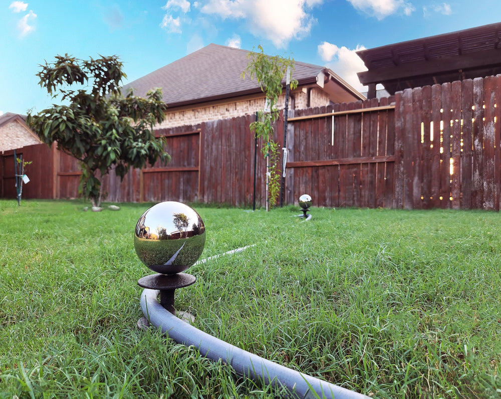 Lulu Decor installed beside flower bed, protects plants during watering