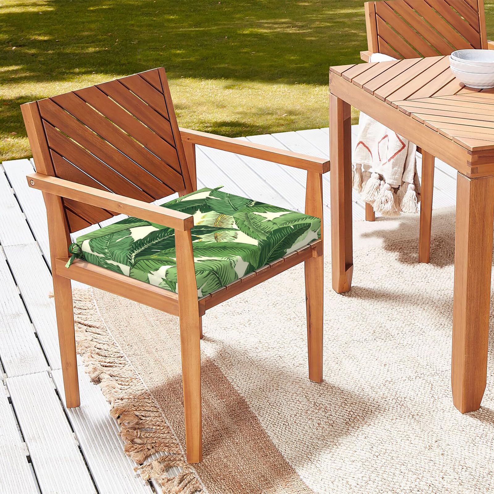 LVTXIII cushion on wicker chaise in a garden setting adding inviting style