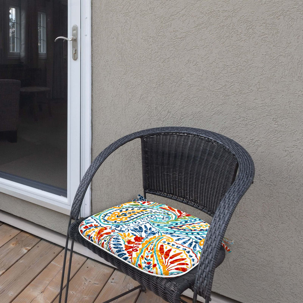 LVTXIII cushion next to hand for scale showing compact fit on standard chairs