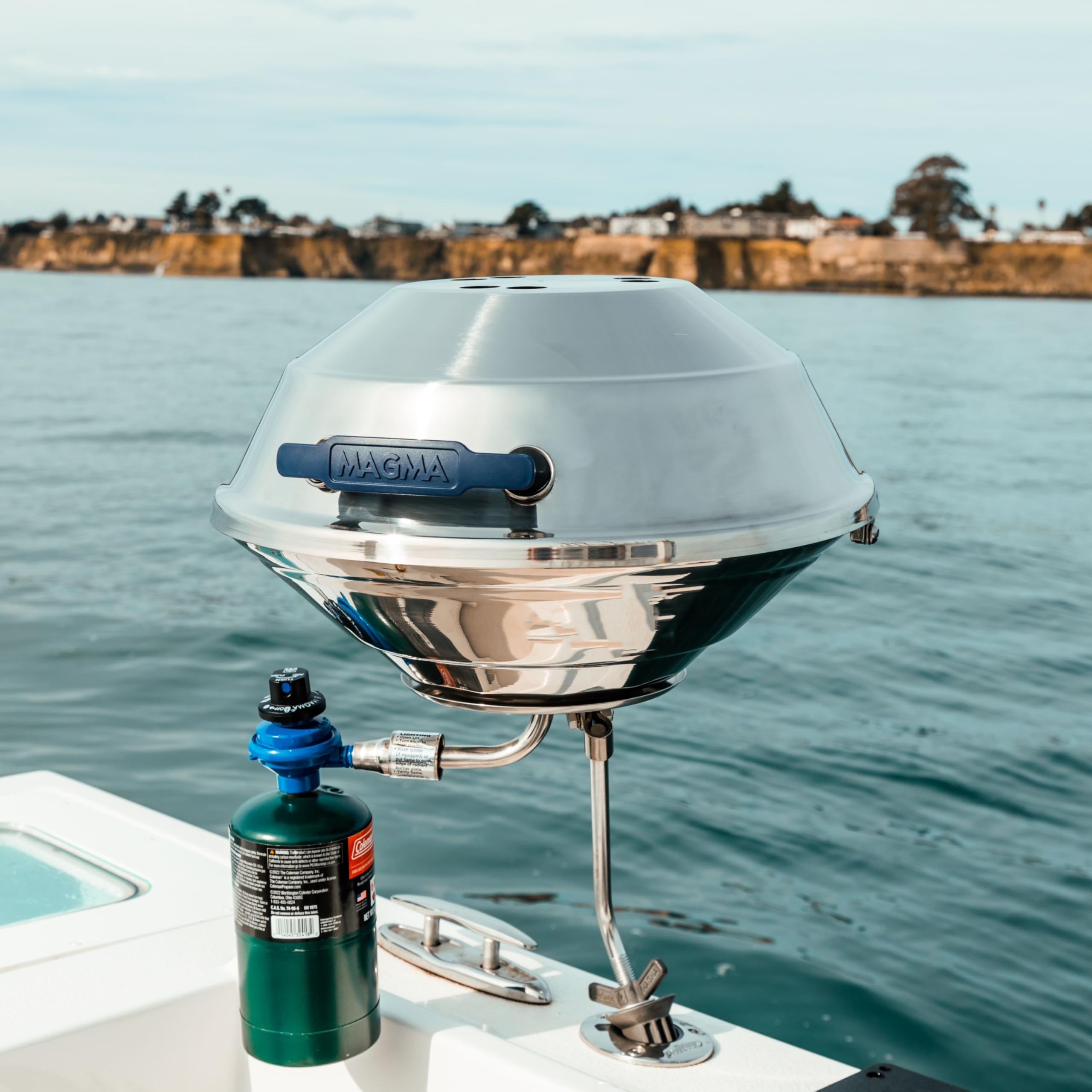 MAGMA grill in use on boat deck demonstrating stable windy-weather cooking performance