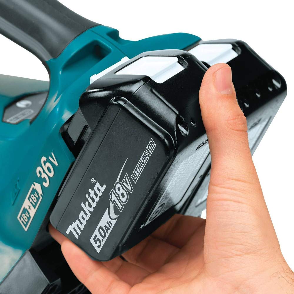 Makita XBU02PT blower clearing leaves in a yard showing quiet efficient cleanup