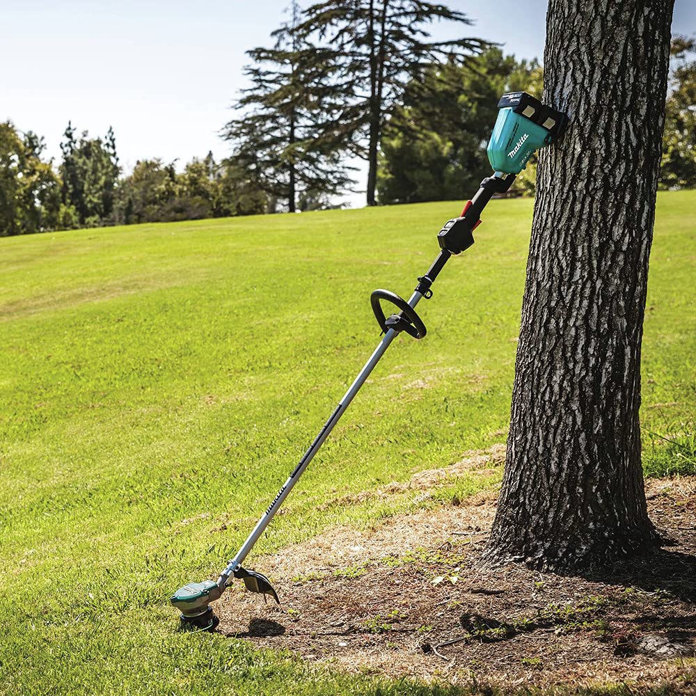 Makita trimming dense grass during a cut test showing effective cutting performance