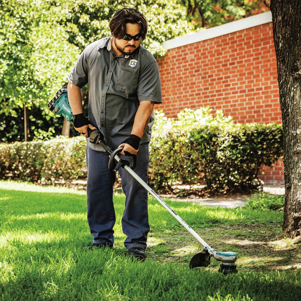 Makita used by landscaper in yard showing professional cordless convenience