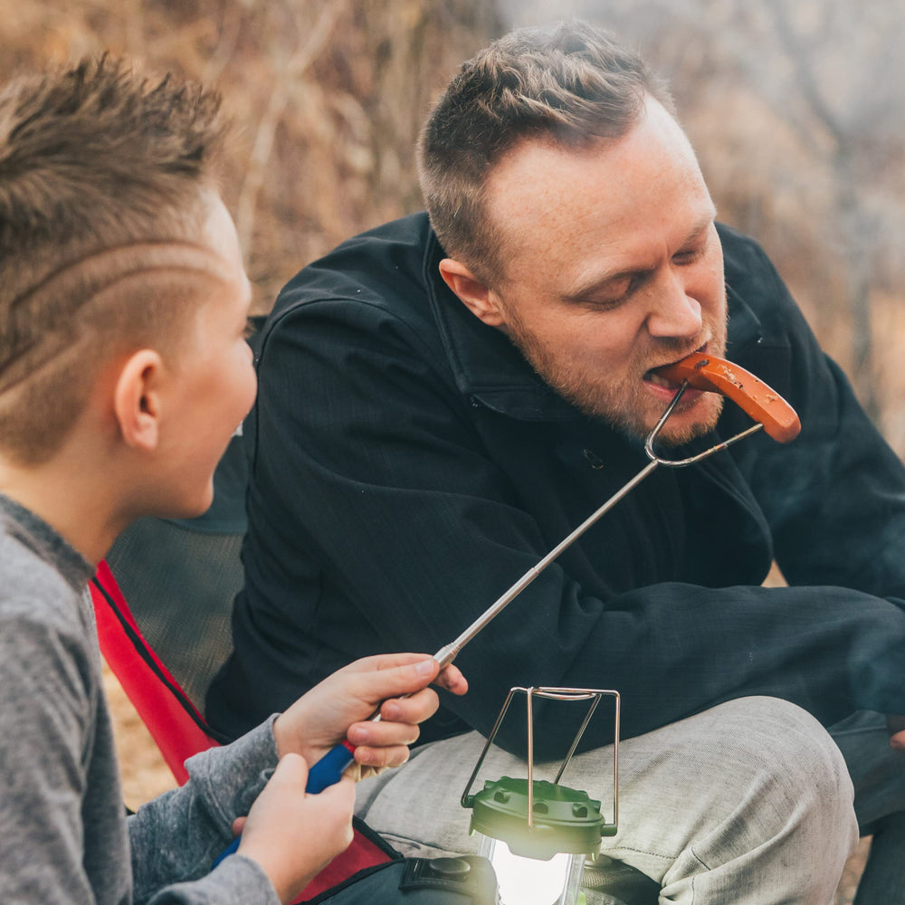 MalloMe roasting a hot dog showing versatile campfire cooking use