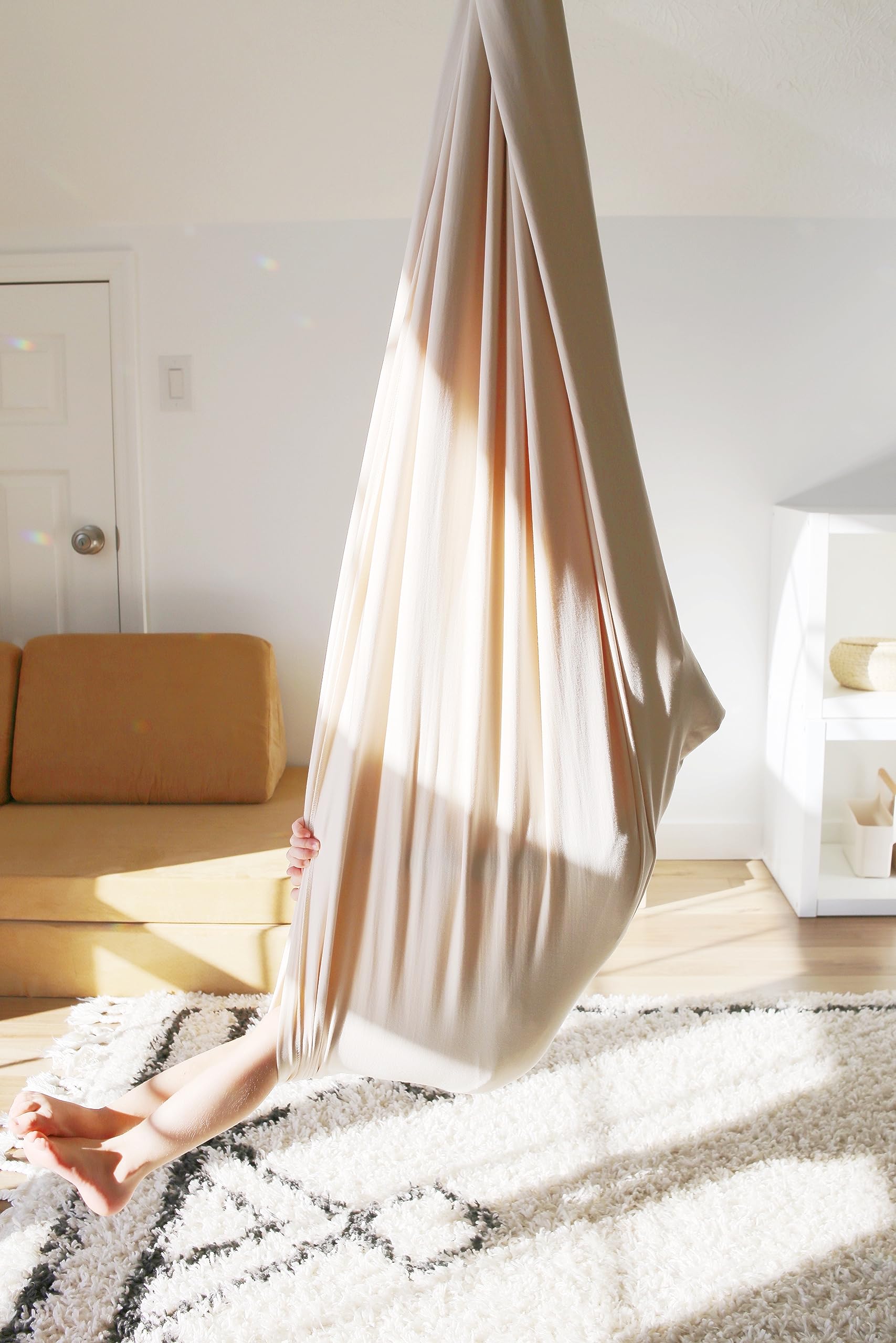 Marlowe & Co sensory swing in a reading nook illustrating cozy, focused downtime