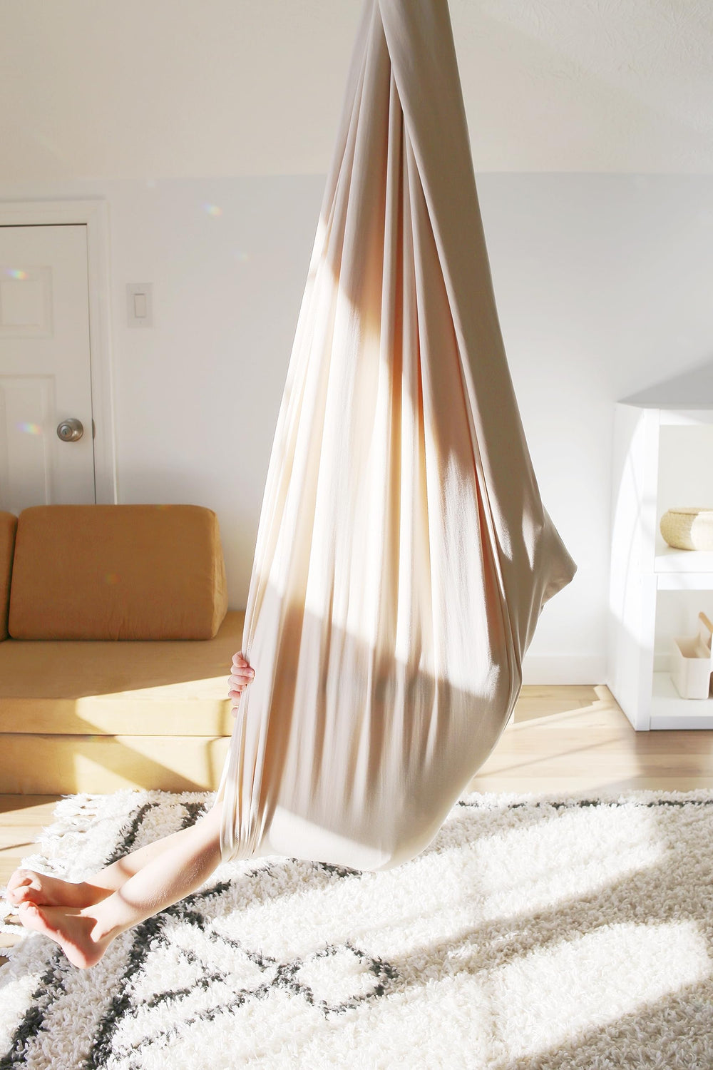 Marlowe & Co sensory swing in a reading nook illustrating cozy, focused downtime