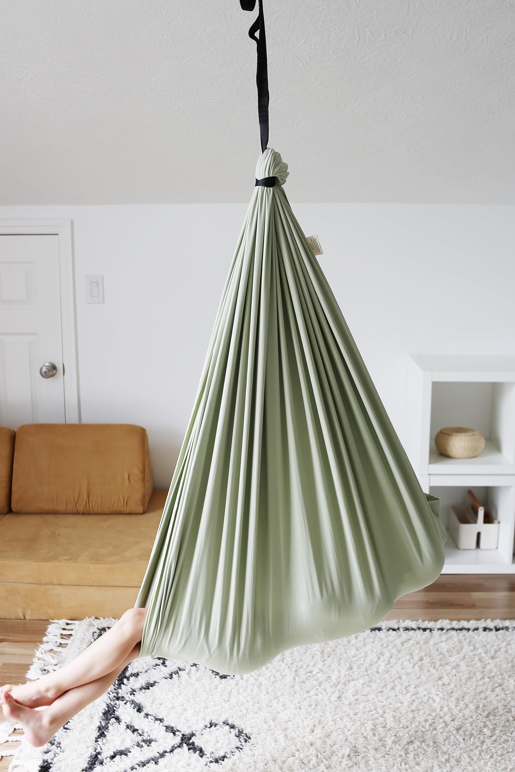 Marlowe & Co swing hung from a backyard beam showing versatile indoor/outdoor use