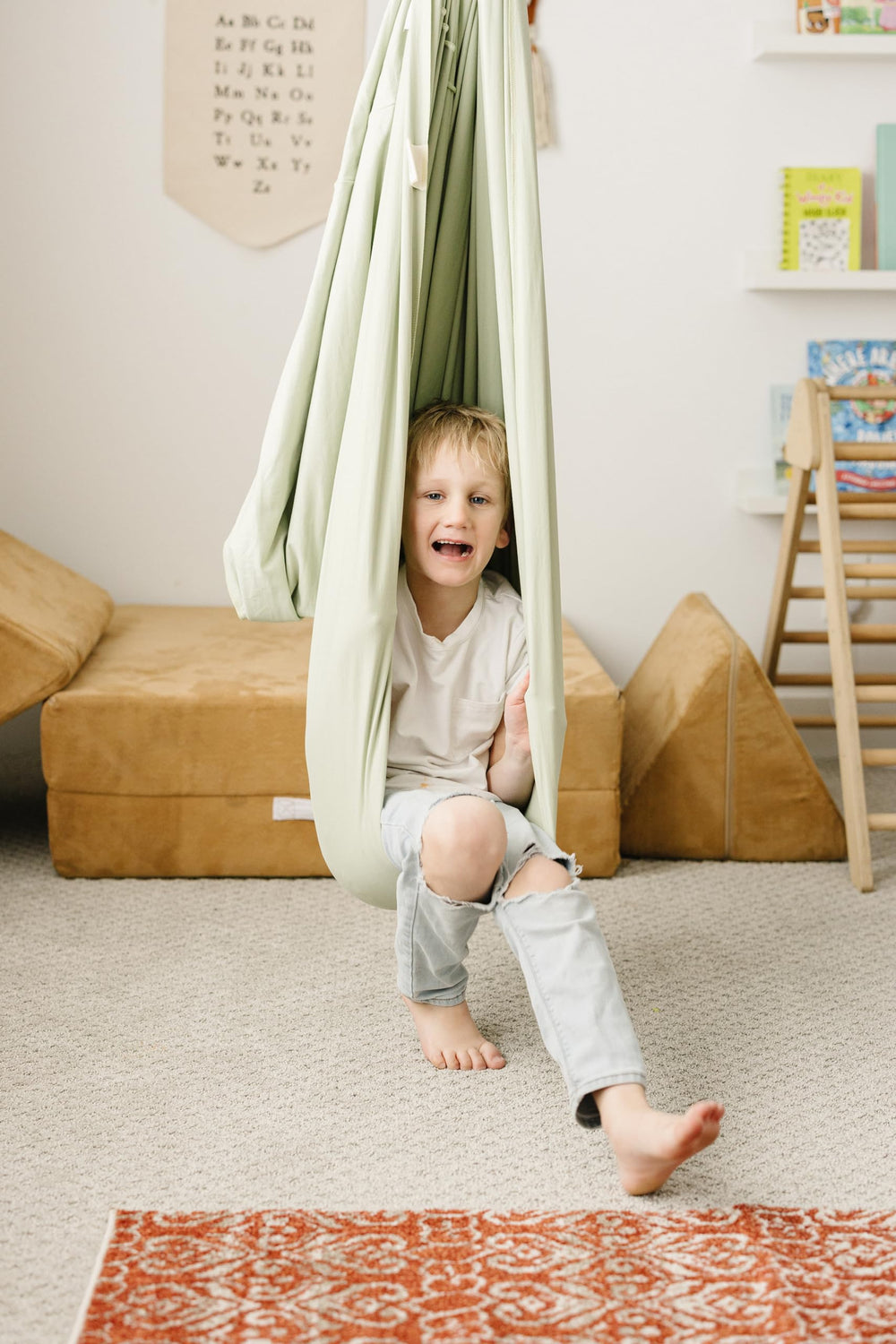 Marlowe & Co swing beside a child for scale showing suitable size and weight capacity
