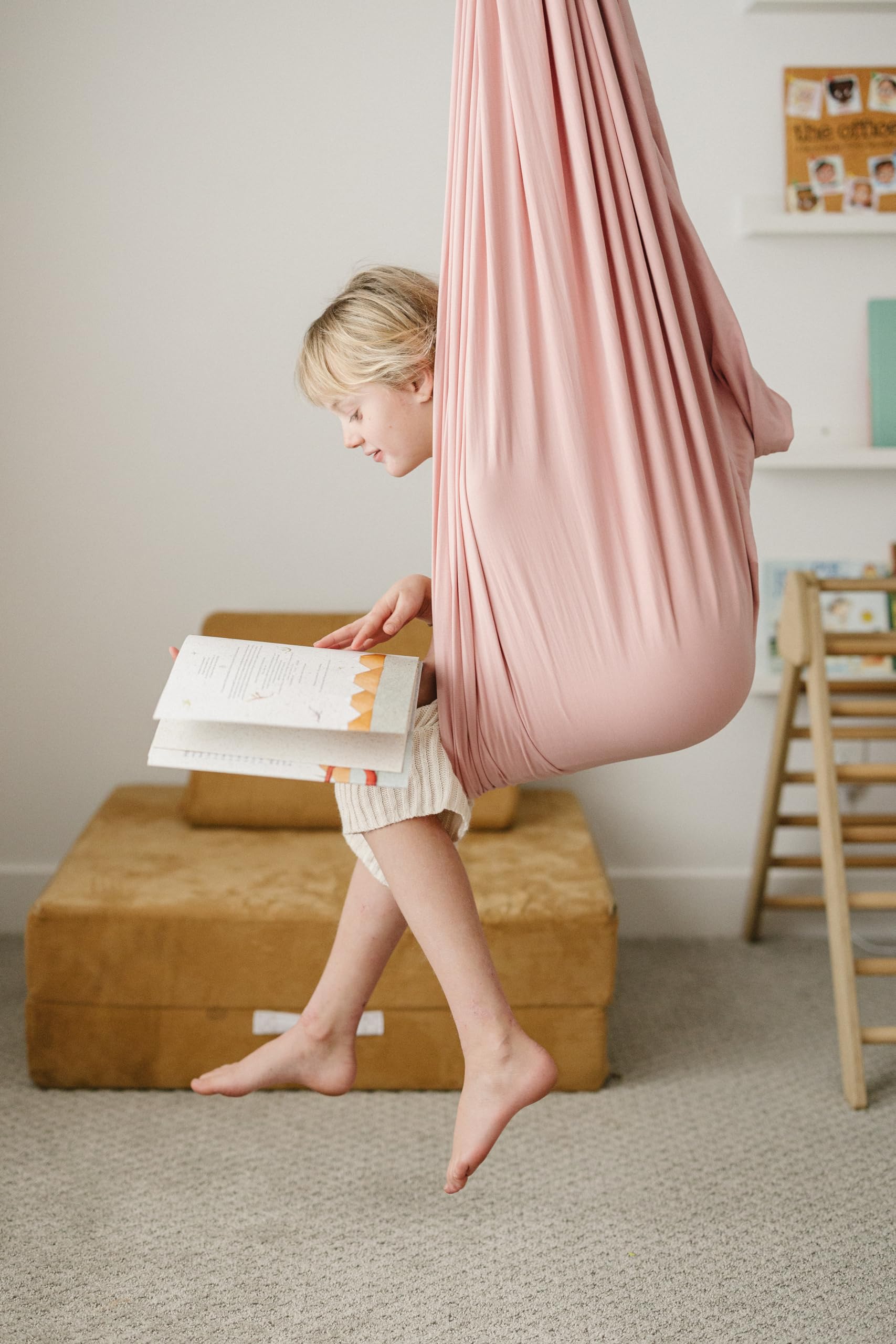 Marlowe & Co swing next to a child for scale showing roomy dimensions and versatile use