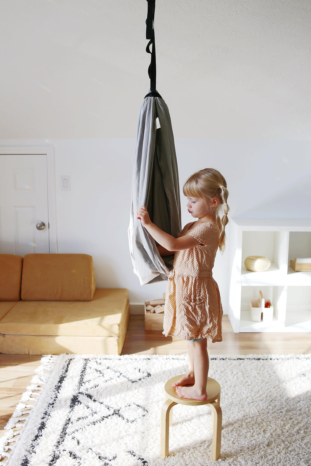 Marlowe & Co swing next to child for scale showing roomy size and safe capacity