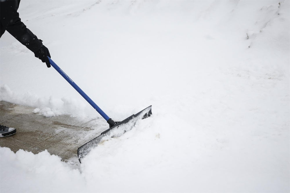 MARSHALLTOWN Polar Pusher removing snow from a wooden deck without damage
