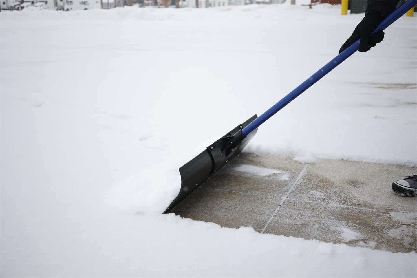 MARSHALLTOWN Polar Pusher beside a broom to show 36-inch blade scale benefit