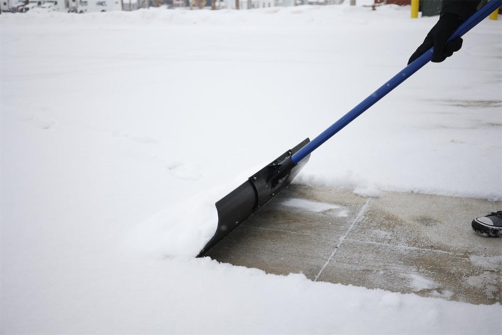 MARSHALLTOWN Polar Pusher beside a broom to show 36-inch blade scale benefit