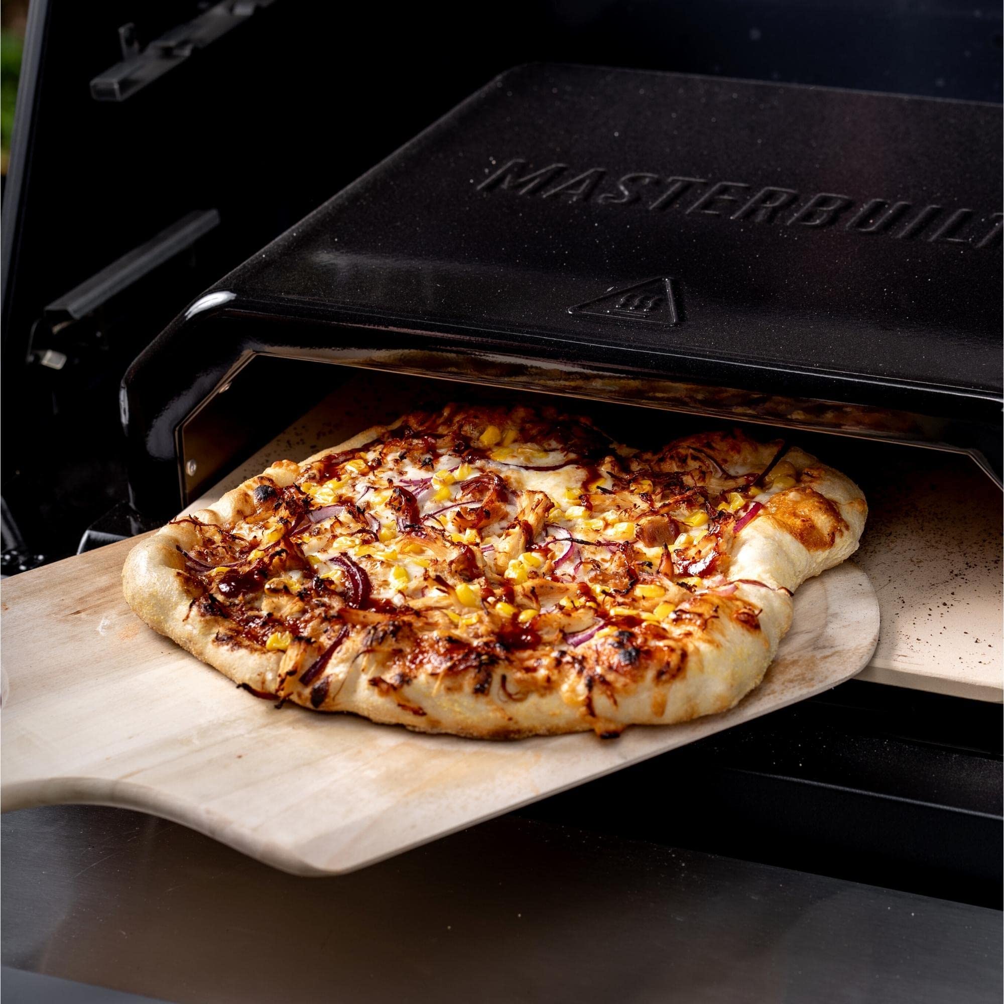 Masterbuilt pizza baking inside insert with crispy crust and even browning