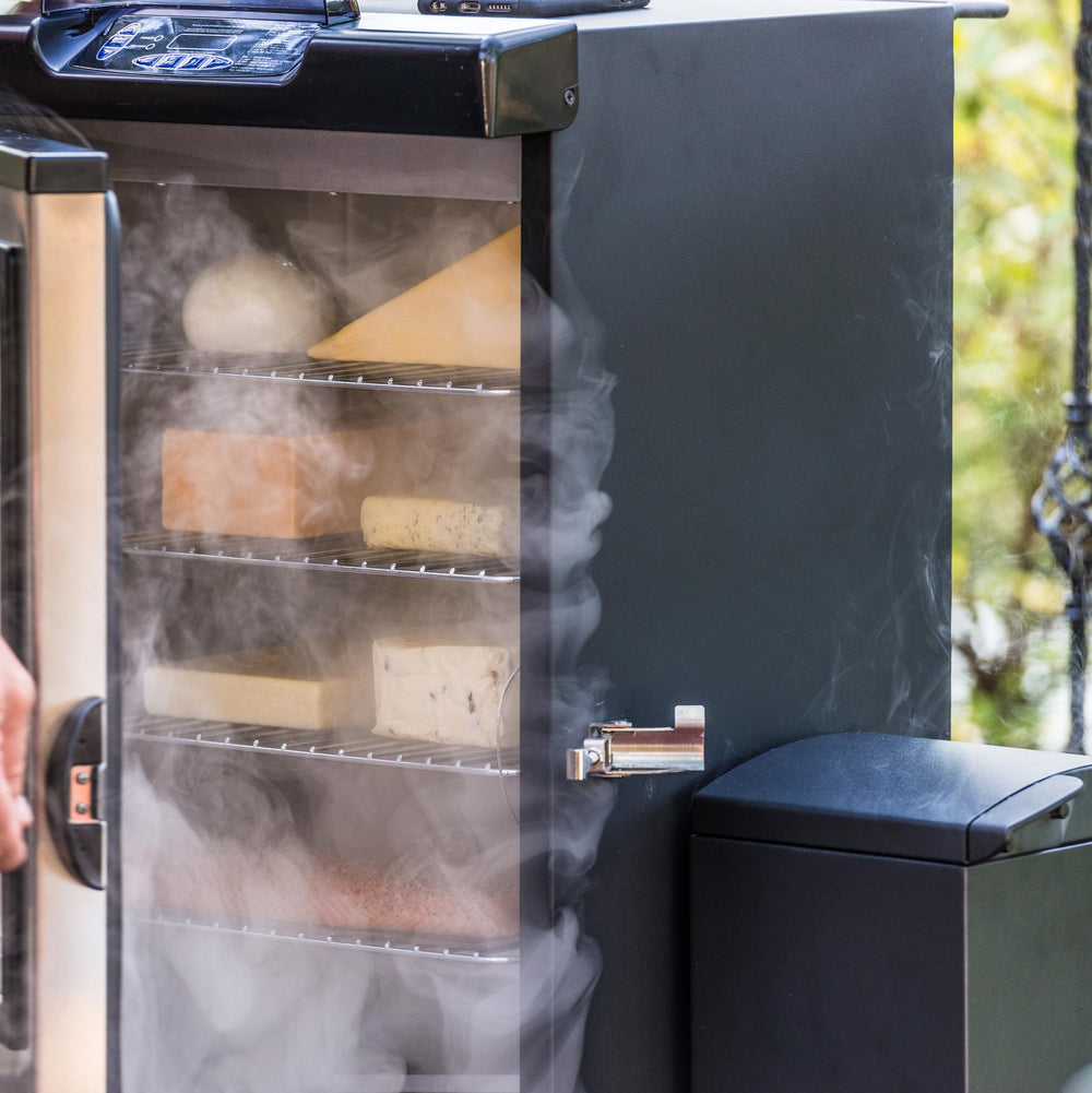 Masterbuilt slow smoker in use with cheese and fish demonstrating gentle smoking benefit