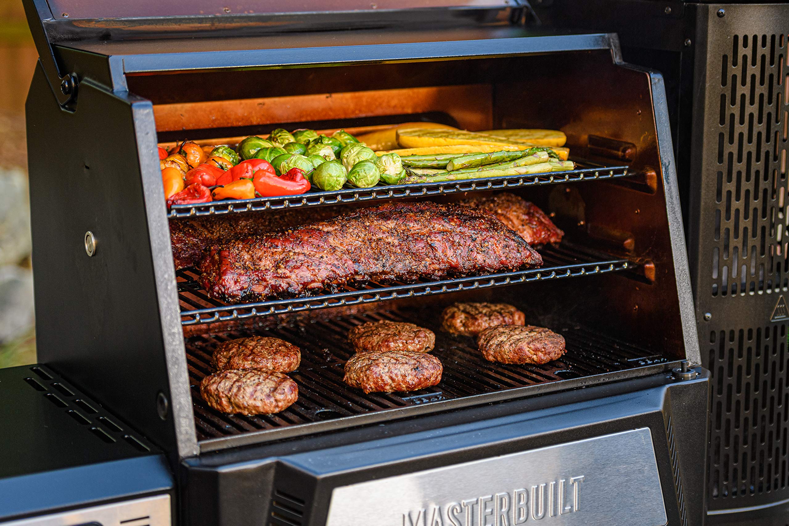 Masterbuilt warming rack in use holding buns and vegetables to free main grate