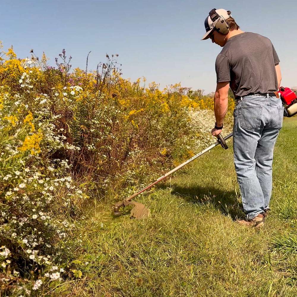 Maxpower trimmer in yard using red line illustrating efficient residential trimming