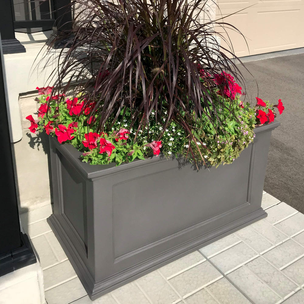 Mayne Fairfield beside chair to show scale and suitability for small outdoor spaces