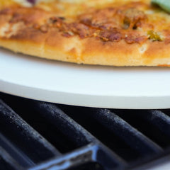 Megamaster stone on gas grill with open lid showing outdoor baking capability advantage
